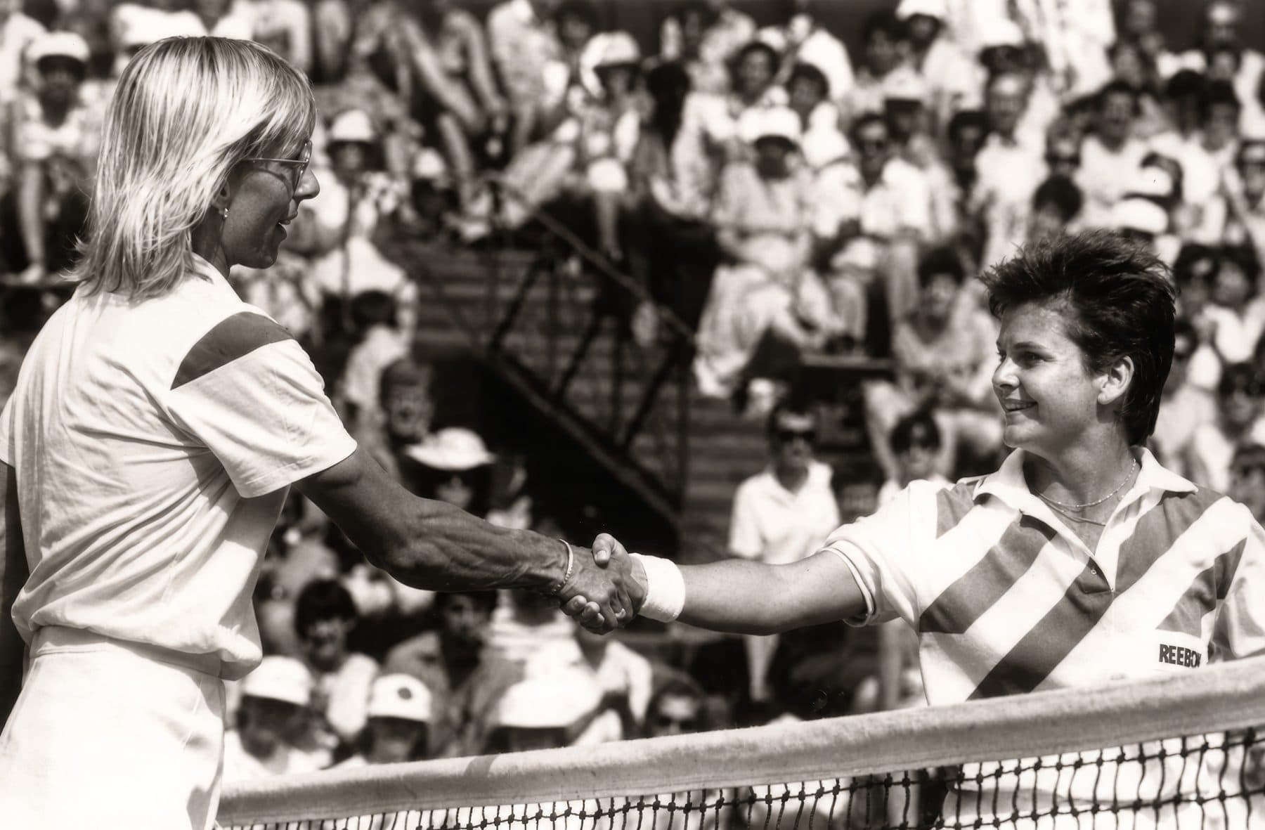 Jane Forman shaking hands with Martina Navratilova at the net on Wimbledon's Centre Court